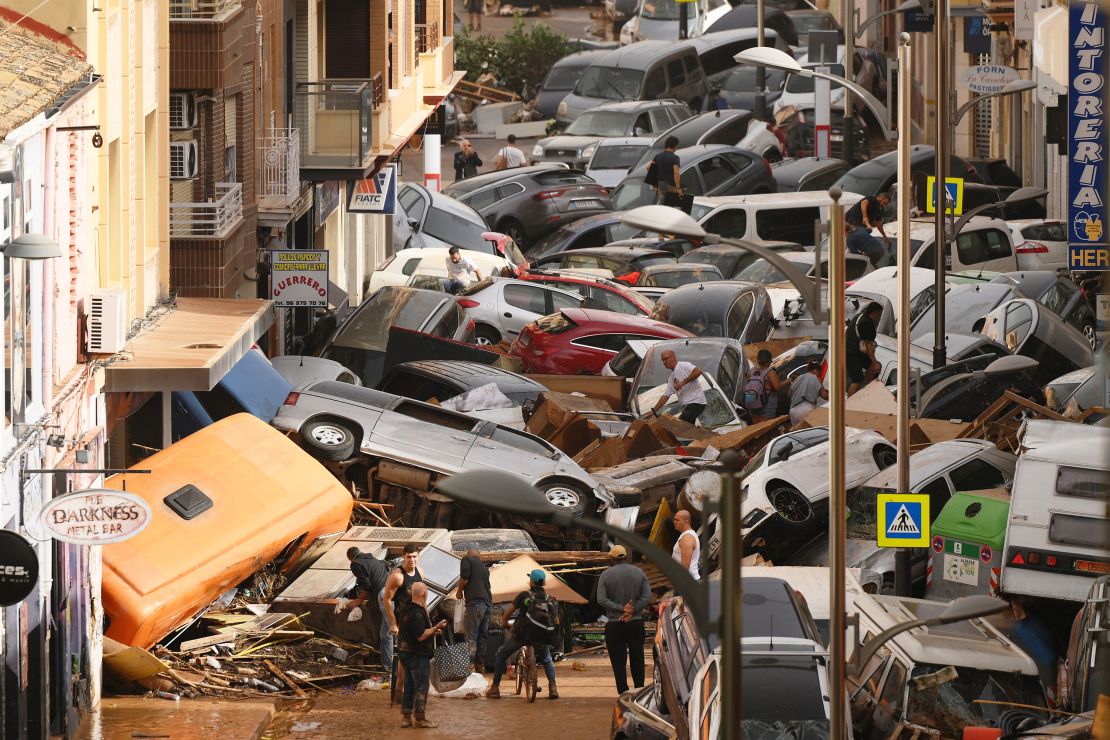 Cars are piled in the street with other debris on October 30, 2024, after flash flooding rocked the Sedaví area of Valencia, Spain.