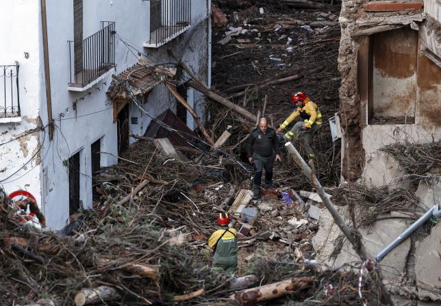 Emergency services workers survey a devastated street in Letur on Wednesday.