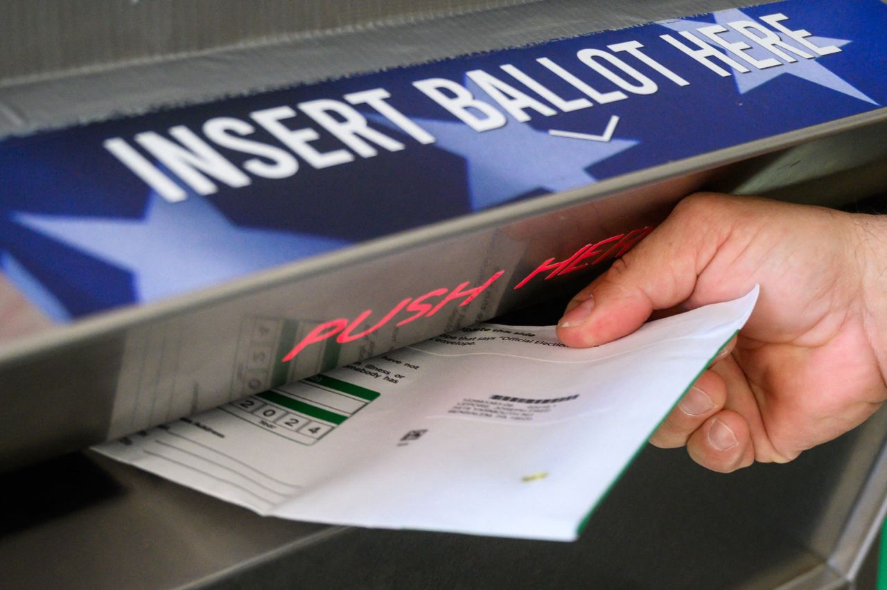 A voter uses a ballot drop box at the Bucks County Administration building in Doylestown, Pennsylvania, on Thursday.