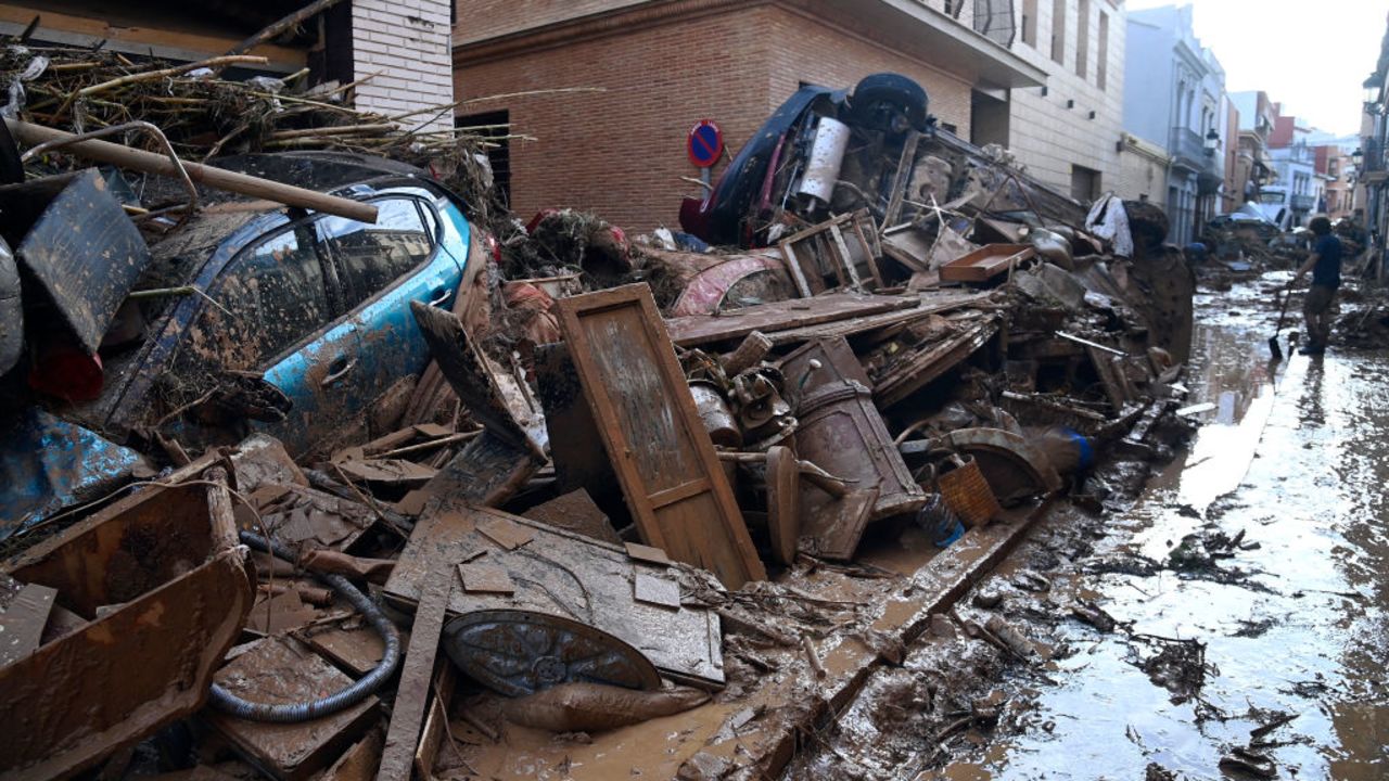 Wreckage of cars and debris are piled up in the streets of Paiporta, on October 31, 2024, covered in mud after flash floods ravaged this area of Valencia region, eastern Spain. Rescuers raced on October 31, 2024 to find survivors and victims of once-in-a-generation floods in Spain that killed at least 95 people and left towns submerged in a muddy deluge with overturned cars scattered in the streets. About 1,000 troops joined police and firefighters in the grim search for bodies in the Valencia region as Spain started three days of mourning. Up to a year's rain fell in a few hours on the eastern city of Valencia and surrounding region on October 29 sending torrents of water and mud through towns and cities. (Photo by JOSE JORDAN / AFP) (Photo by JOSE JORDAN/AFP via Getty Images)