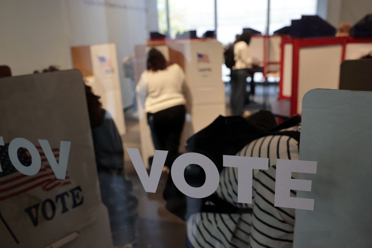 People cast their in-person early ballot for the 2024 general election at a polling station in Ann Arbor, Michigan, on October 31.