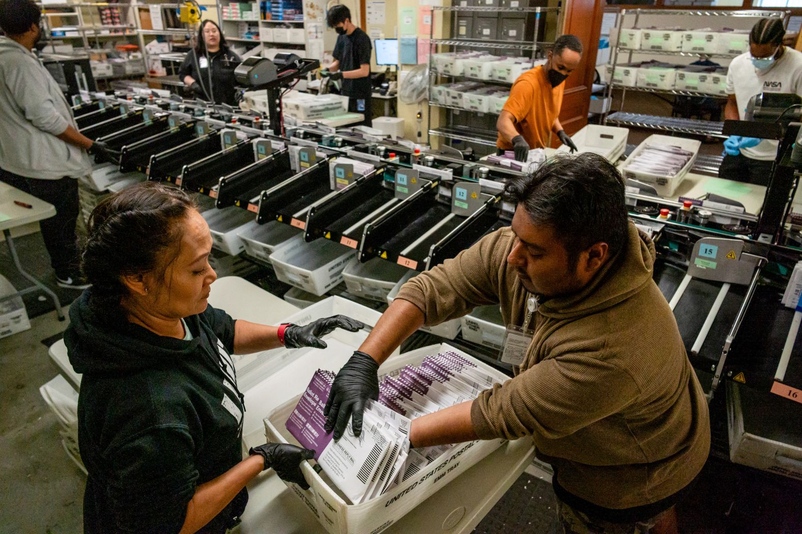 Election workers sort ballots during early voting in San Francisco on October 31.