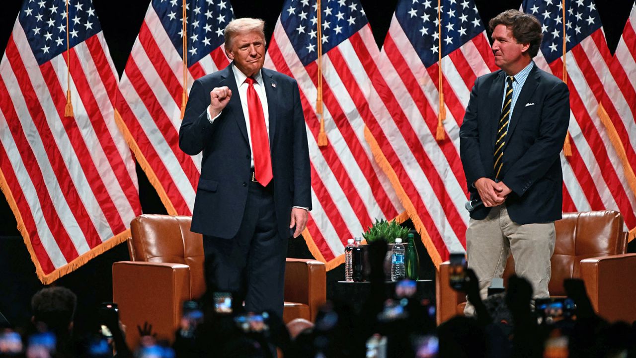 Republican presidential candidate, former President Donald Trump arrives for a live interview with commentator Tucker Carlson, during the finale of the Tucker Carlson Live Tour at Desert Diamond Arena in Glendale, Arizona, on October 31, 2024.