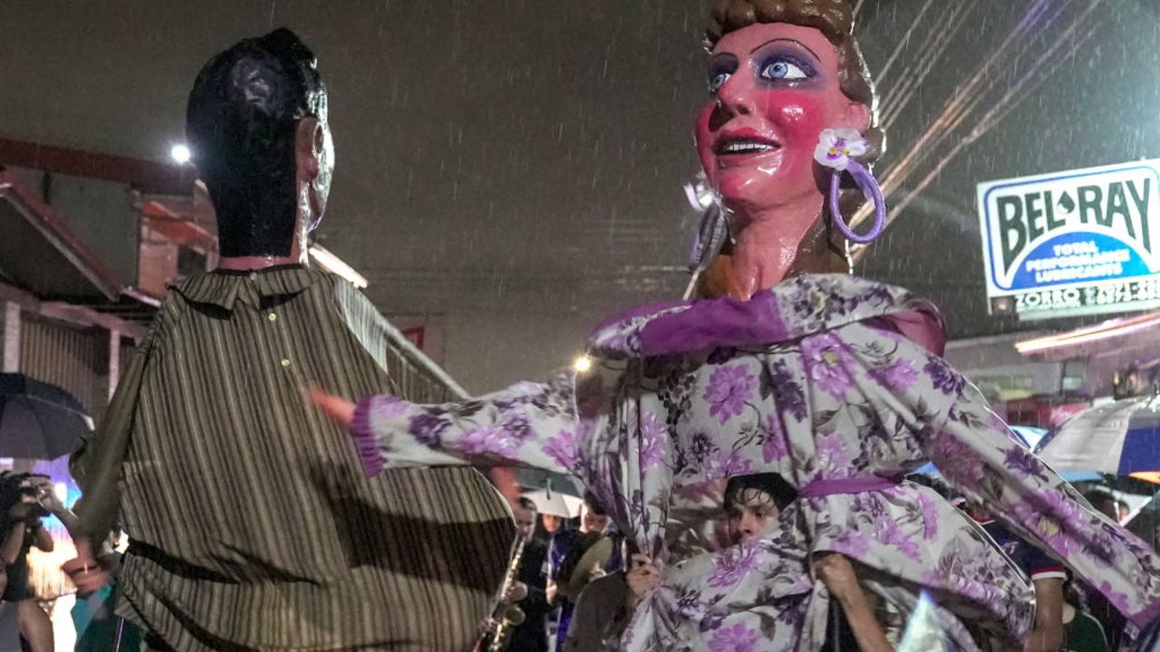 People take part in a parade for Dia de la Mascarada dressed in homemade masks and costumes, as an alternative tradition to Halloween, in Barva, north of the capital San Jose, on October 31, 2024. (Photo by ALBERTO PEÑA / AFP) (Photo by ALBERTO PENA/AFP via Getty Images)