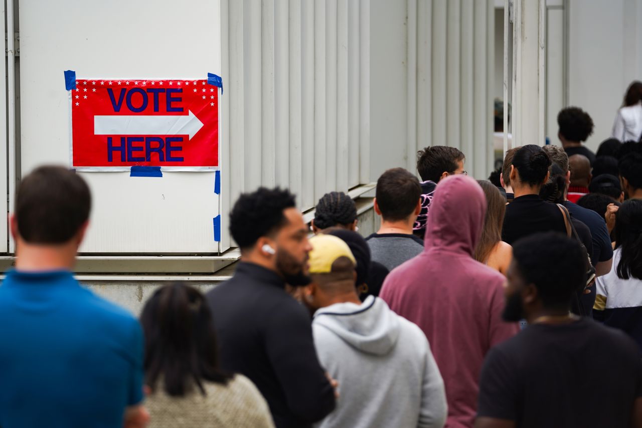 Voters wait in line to cast their ballots during early voting on November 1 in Atlanta.