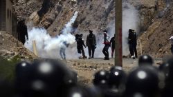 Riot police fire tear gas during clashes with supporters of former Bolivian President Evo Morales in Parotani, Cochabamba department, Bolivia, on November 1, 2024. Supporters of Bolivia's ex-president Evo Morales stormed a barracks in central Chapare province and took around 20 soldiers hostage, military sources said Friday, marking a dramatic escalation in their standoff with the state. (Photo by FERNANDO CARTAGENA / AFP) (Photo by FERNANDO CARTAGENA/AFP via Getty Images)