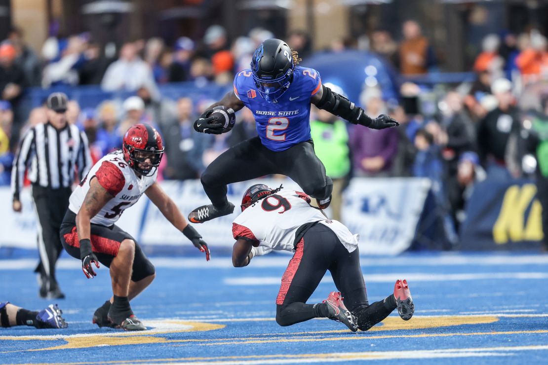 Jeanty overcomes safety Dalesean Staley's tackle attempt during the game.