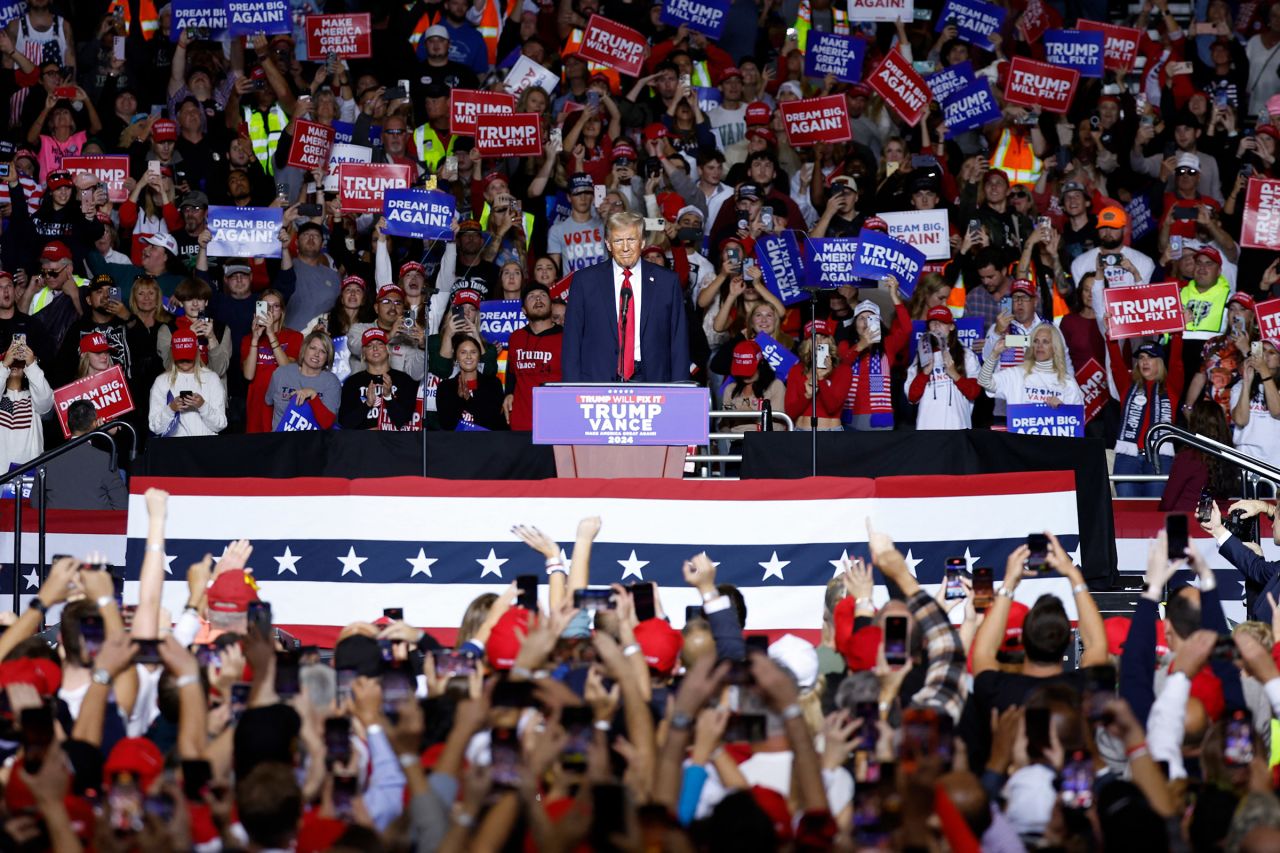 Supporters cheer as former President Donald Trump arrives at the podium to speak during a campaign rally at the Fiserv Forum in Milwaukee, Wisconsin, November 1, 2024.