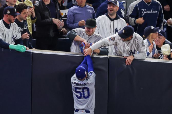 A pair of Yankees fans were ejected from Game 4 after one of them grabbed Betts' glove and the other grabbed his arm when the Dodgers right fielder tried to catch a foul ball in the first inning Tuesday.