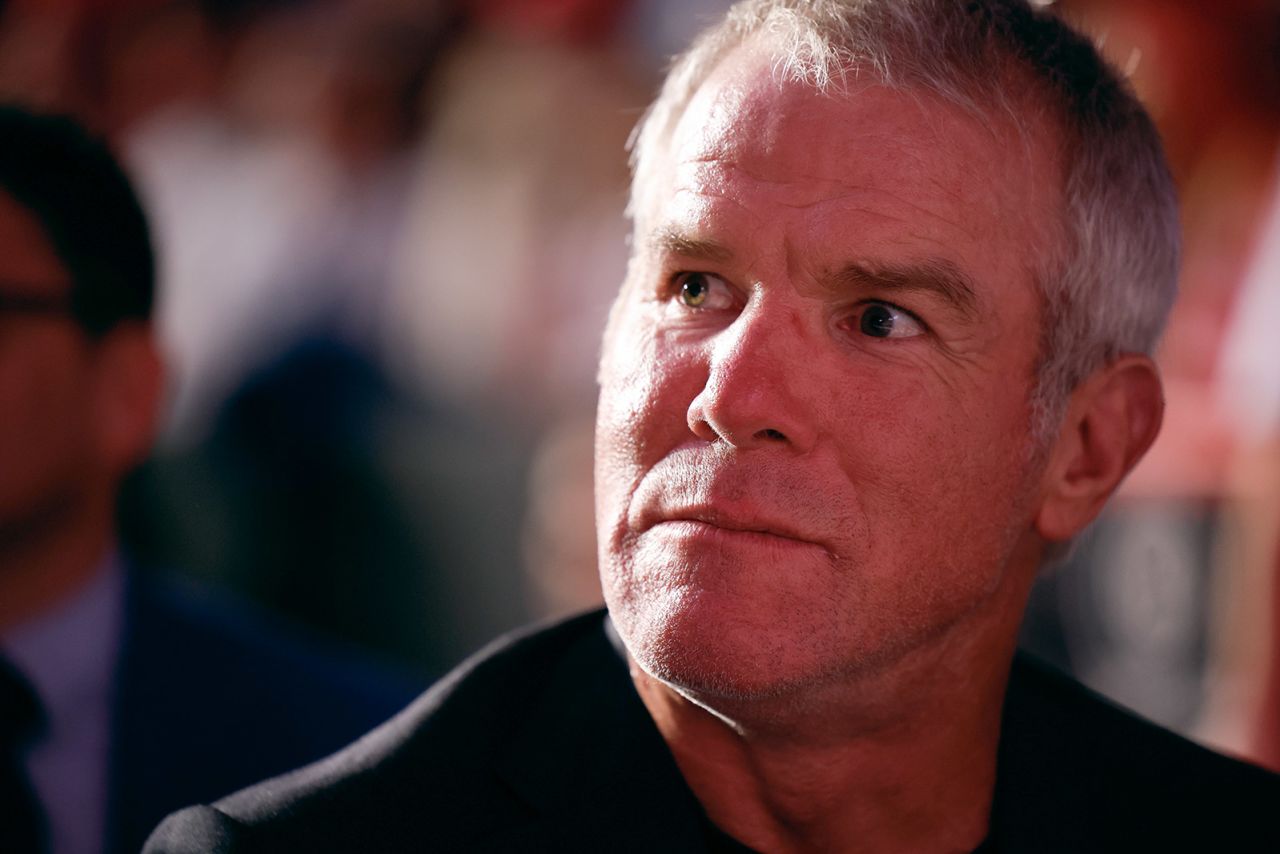 Former NFL quarterback Brett Favre listens as former President Donald Trump speaks during a campaign event at the Resch Center in Green Bay, Wisconsin, on October 30, 2024.