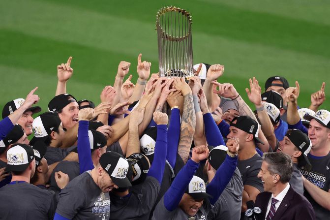 The Dodgers celebrate with the Commissioner's Trophy after winning Game 5.