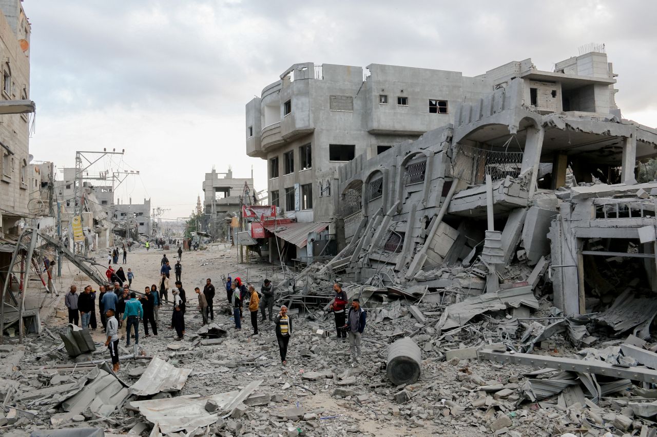 Residents walk through the rubble following an Israeli airstrike in al-Zawaida, Gaza on November 1, 2024.