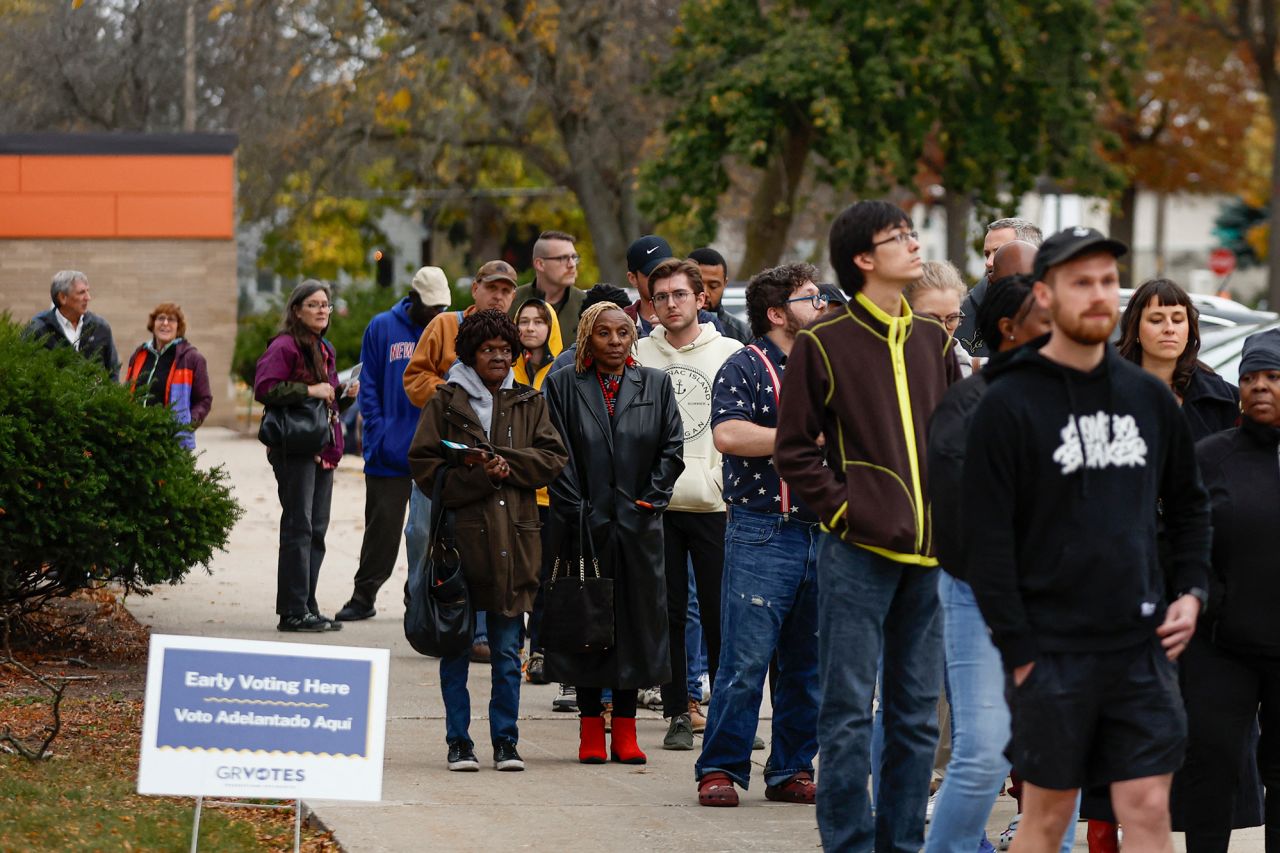 People wait in line to vote during early voting at a polling station in Grand Rapids, Michigan, on Sunday.