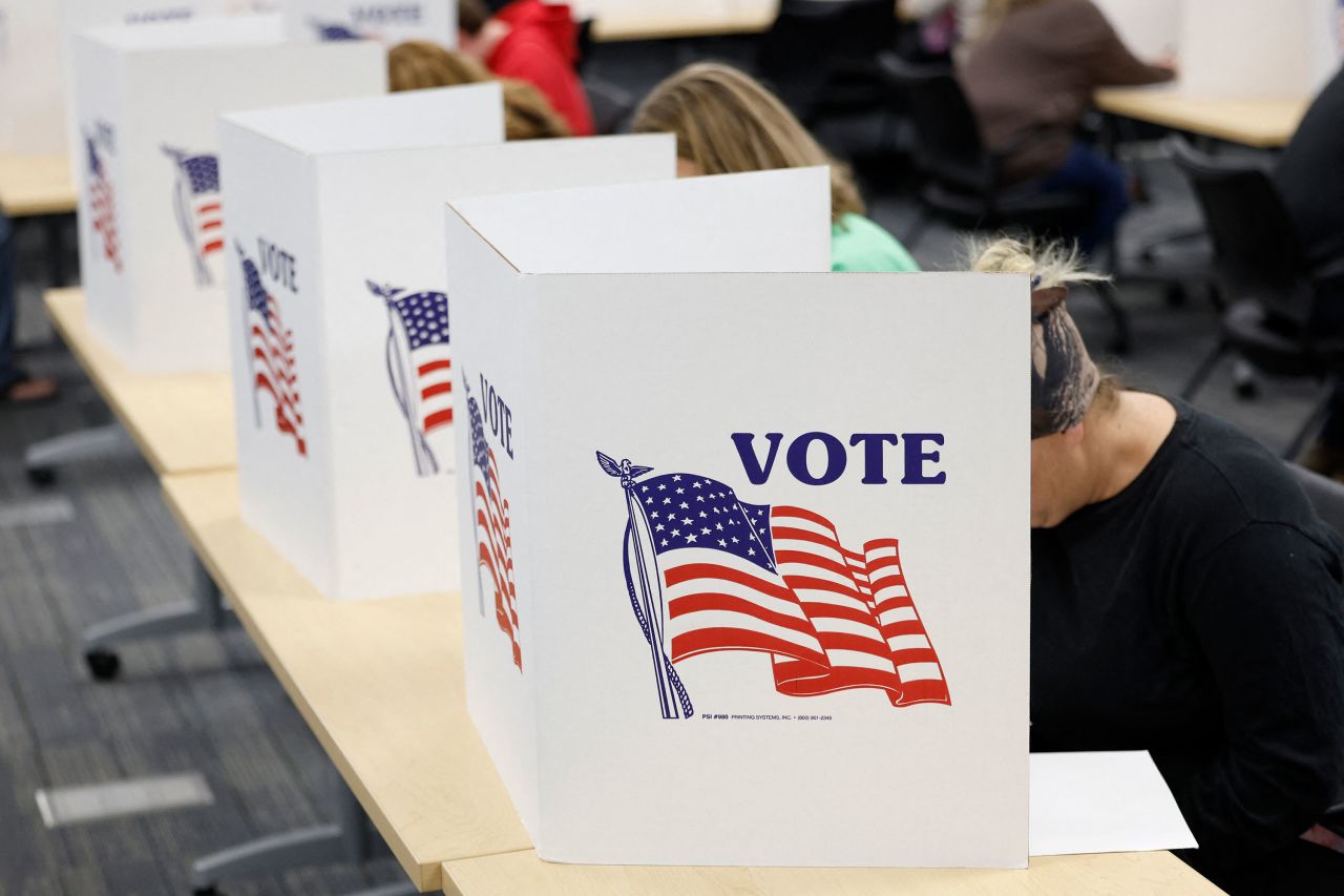 People fill out ballots on the last day of early voting in Howell, Michigan, on Sunday.