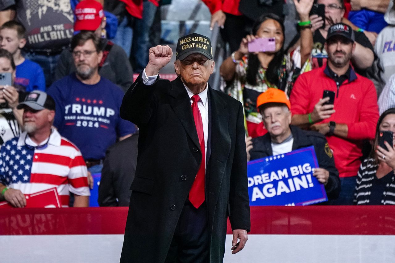 Former US President and Republican presidential candidate Donald Trump pumps his fist after speaking at the end of a campaign rally at Atrium Health Amphitheater in Macon, Georgia, on November 3.