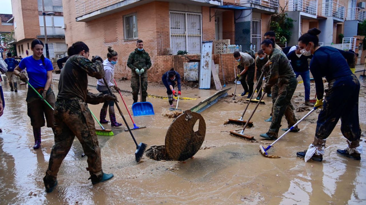 Members of the military and volunteers wok in clean up efforts in Alfafar, in the region of Valencia, eastern Spain, on November 4, 2024,  following devastating floods. The death toll from Spain's worst floods in a generation has climbed to 217, according to resuers. (Photo by JOSE JORDAN / AFP) (Photo by JOSE JORDAN/AFP via Getty Images)