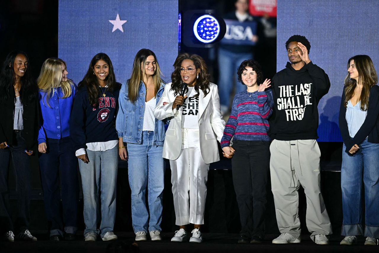 US television producer Oprah Winfrey arrives on stage with 10 first-time Philadelphia voters during a rally for Kamala Harris in Philadelphia, Pennsylvania, on November 4, 2024.