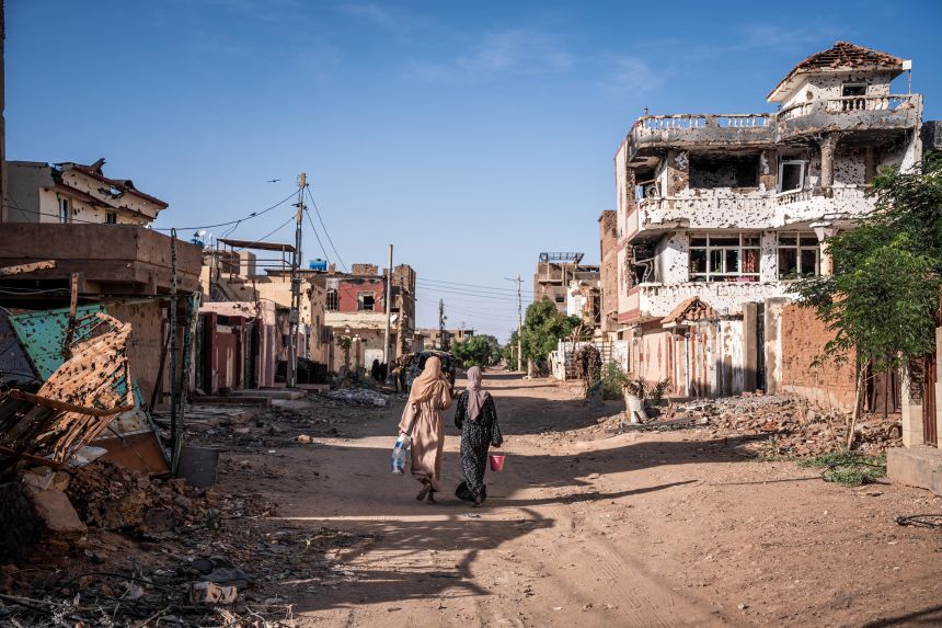 Women walk through a neighborhood in Omdurman on November 2, 2024.