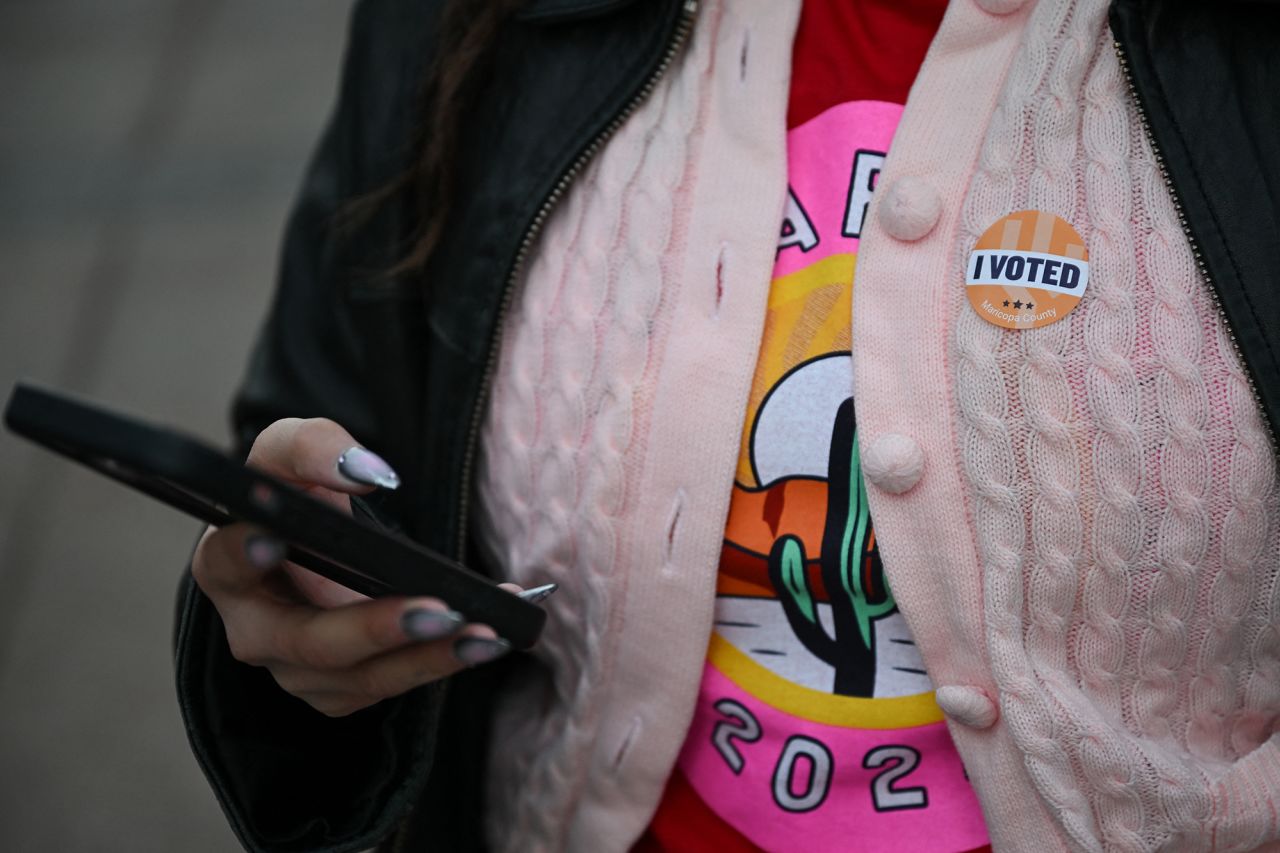 A person wears an "I Voted" sticker outside of a polling station in Phoenix, Arizona, on Election Day.