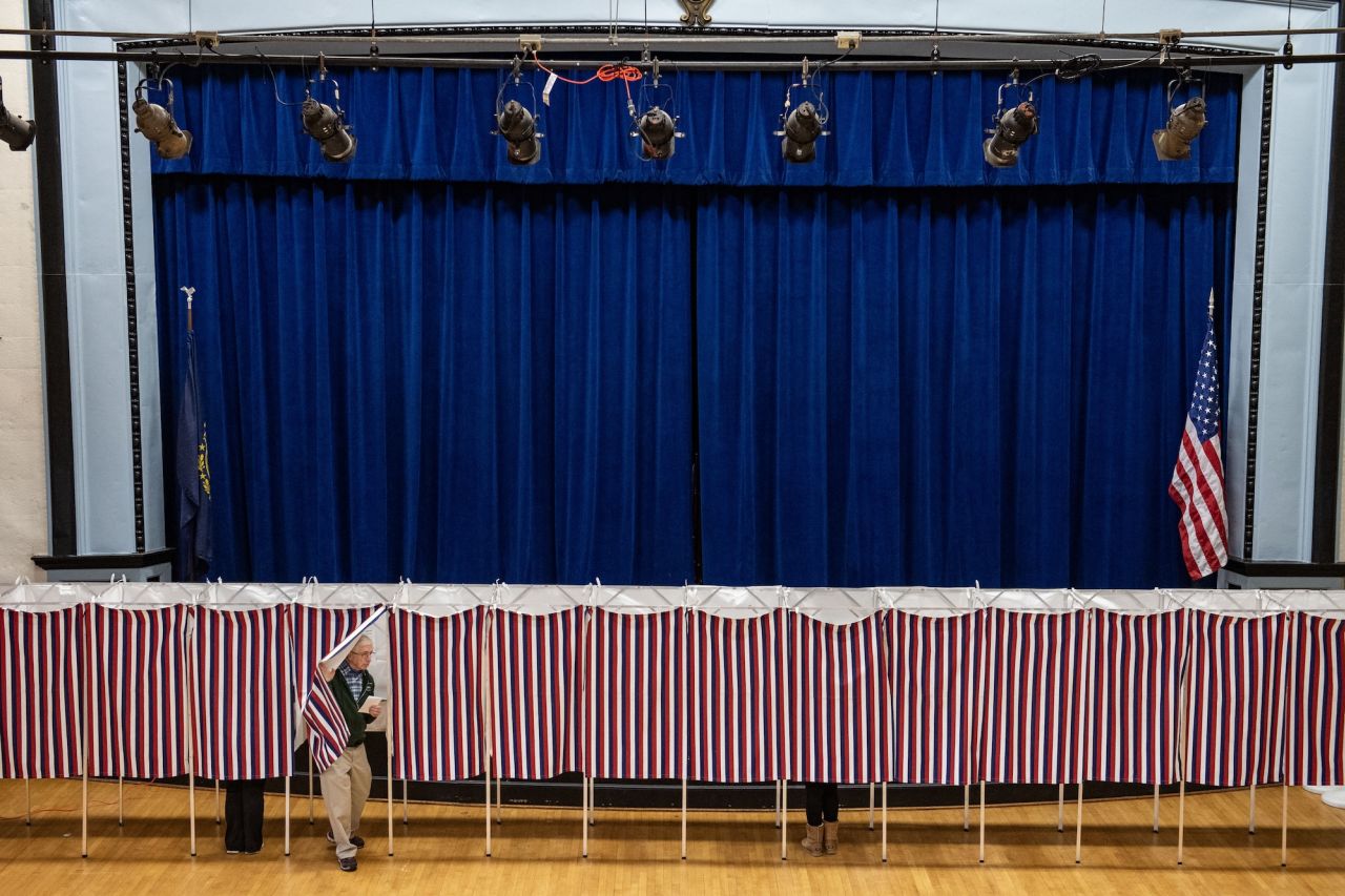 A man exits a voting booth at a polling station in Lancaster, New Hampshire, on Election Day, November 5.