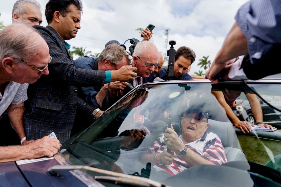 Rudy Giuliani, former attorney for former U.S. President Donald Trump, center, speaks to members of the media outside a 2024 presidential election polling place at the Mandel Community Center in Palm Beach, Florida, U.S., Tuesday, Nov. 5, 2024.