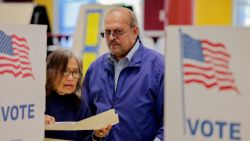 People revi,ew their ballots at a voting booth in Fairfax, Virginia on November 5, 2024. Americans vote in the presidential election between Democratic candidate Kamala Harris and Republican candidate Donald Trump. (Photo by Ali Khaligh / Middle East Images / Middle East Images via AFP) (Photo by ALI KHALIGH/Middle East Images/AFP via Getty Images)