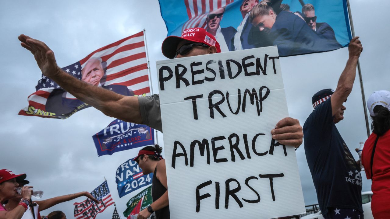 Supporters of former US President and Republican presidential candidate Donald Trump show their support on Election Day near his residence at the Mar-a-Lago Club, in West Palm Beach, Florida, on November 5, 2024. (Photo by Giorgio Viera / AFP) (Photo by GIORGIO VIERA/AFP via Getty Images)