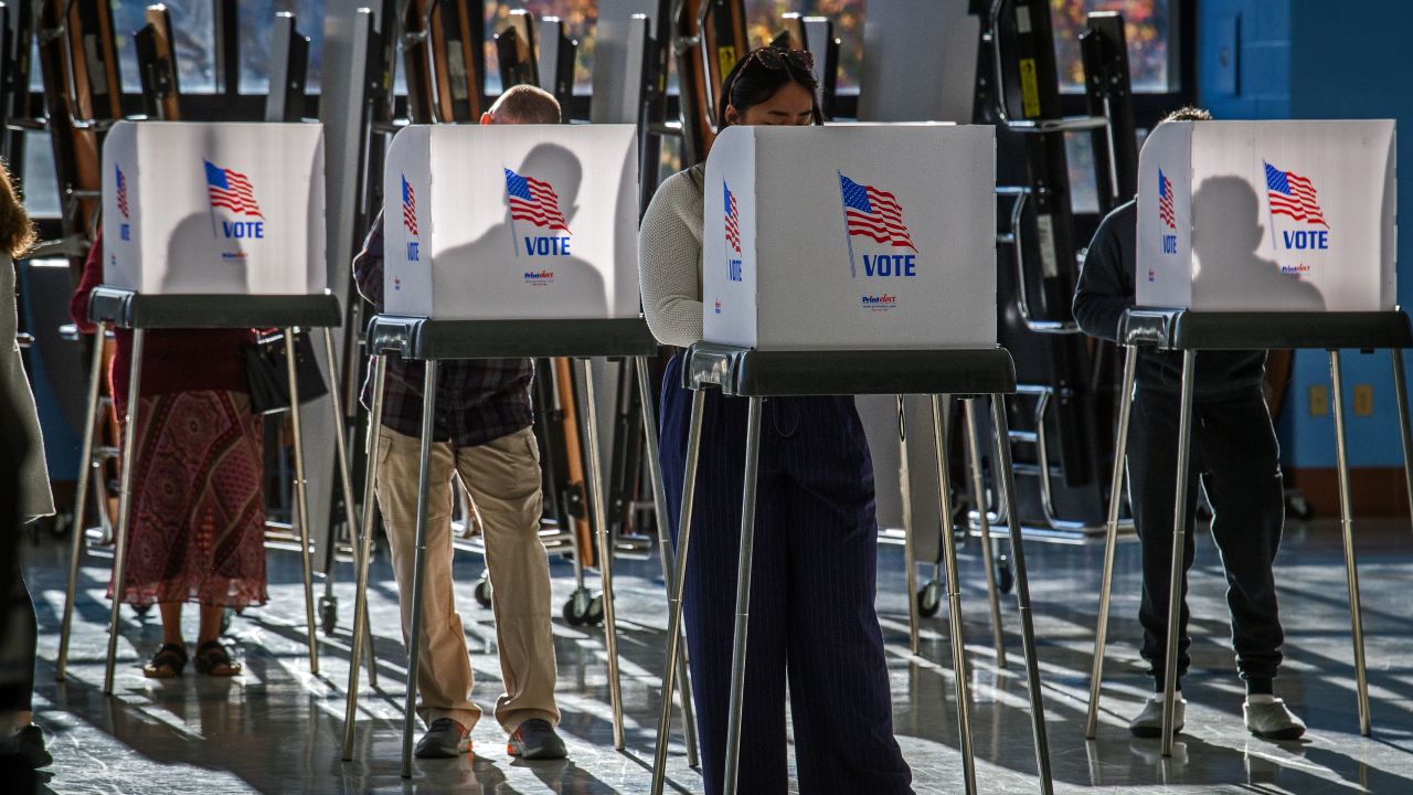 Montgomery County voters silhouetted by early morning sunlight in Clarksburg, Maryland.
