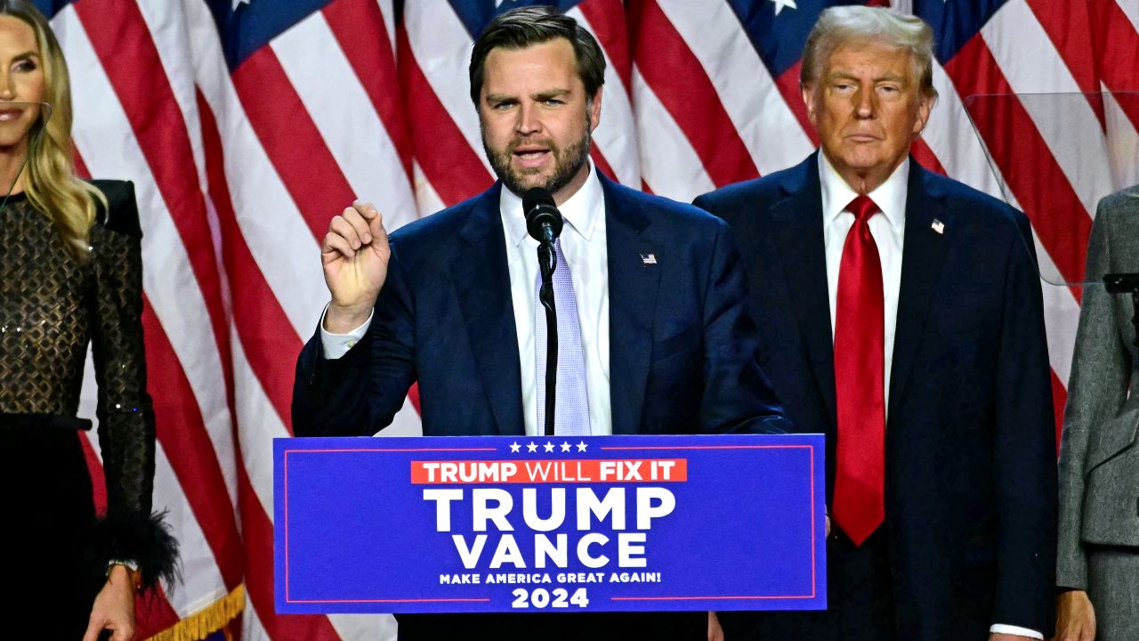 US Senator from Ohio and Republican vice presidential candidate J.D. Vance (C) speaks alongside former US President and Republican presidential candidate Donald Trump during an election night event at the West Palm Beach Convention Center in West Palm Beach, Florida, on November 6, 2024. Republican former president Donald Trump closed in on a new term in the White House early November 6, 2024, just needing a handful of electoral votes to defeat Democratic Vice President Kamala Harris. (Photo by Jim WATSON / AFP) (Photo by JIM WATSON/AFP via Getty Images)