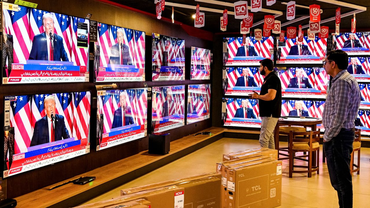 Men watch a televison broadcast at a shop in Islamabad on November 6, 2024, featuring US former president and Republican presidential candidate Donald Trump as he addresses an election night event at Florida. Republican former president Donald Trump closed in on a new term in the White House early November 6, 2024, just needing a handful of electoral votes to defeat Democratic Vice President Kamala Harris. (Photo by Farooq NAEEM / AFP) (Photo by FAROOQ NAEEM/AFP via Getty Images)