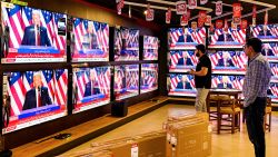 Men watch a televison broadcast at a shop in Islamabad on November 6, 2024, featuring US former president and Republican presidential candidate Donald Trump as he addresses an election night event at Florida. Republican former president Donald Trump closed in on a new term in the White House early November 6, 2024, just needing a handful of electoral votes to defeat Democratic Vice President Kamala Harris. (Photo by Farooq NAEEM / AFP) (Photo by FAROOQ NAEEM/AFP via Getty Images)