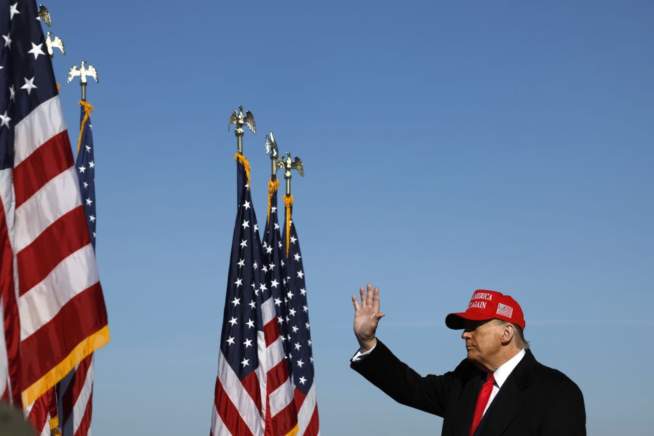 Former President Donald Trump waves as he finishes a campaign rally in Litiz, Pennsylvania, on Sunday.