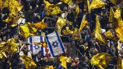 Maccabi supporters wave yellow flags next to Israeli flags during the UEFA Europa League, League phase - Matchday 4, football match between Ajax Amsterdam and Maccabi Tel Aviv at the Johan-Cruijff stadium, in Amsterdam on November 7, 2024.