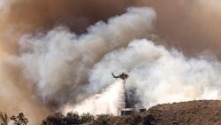 CORRECTION / A fire helicopter makes a drop over the Mountain Fire as it scorches acres, the wildfire fueled by strong Santa Ana winds, in Moorpark, California, on November 7, 2024. Thousands of people were urged to flee an out-of-control wildfire burning around communities near Los Angeles on November 7, with scores of homes already lost to the fast-moving flames.
Fierce seasonal winds had cast embers up to three miles (five kilometers) from the seat of the fire around Camarillo, with new spots burning on hillsides, farmland and in residential areas.
The Mountain Fire grew rapidly from a standing start early November 6, and by the following day had consumed 20,485 acres (8,290 hectares), with towering flames leaping unpredictably and sending residents scrambling. (Photo by ETIENNE LAURENT / AFP) / "The erroneous mention[s] appearing in the metadata of this photo by ETIENNE LAURENT has been modified in AFP systems in the following manner: [Moorpark] instead of [Santa Paula]. Please immediately remove the erroneous mention[s] from all your online services and delete it (them) from your servers. If you have been authorized by AFP to distribute it (them) to third parties, please ensure that the same actions are carried out by them. Failure to promptly comply with these instructions will entail liability on your part for any continued or post notification usage. Therefore we thank you very much for all your attention and prompt action. We are sorry for the inconvenience this notification may cause and remain at your disposal for any further information you may require." (Photo by ETIENNE LAURENT/AFP via Getty Images)