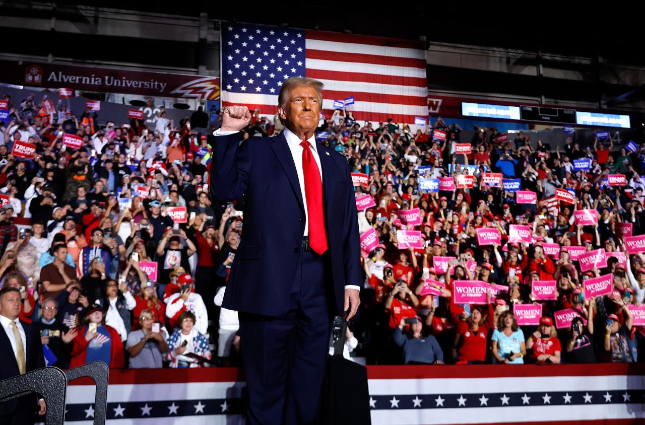 Former President Donald Trump holds up a fist at a campaign rally at the Santander Arena in Reading, Pennsylvania, on Monday.