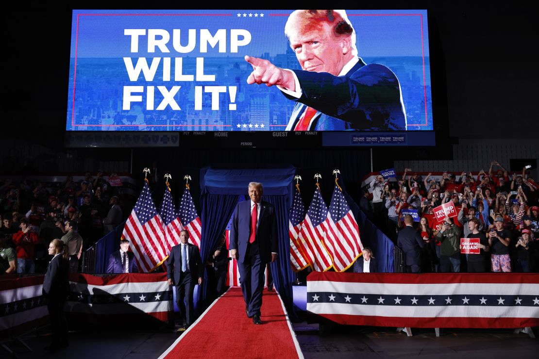 US President Donald Trump takes the stage for his last rally of the election year in Grand Rapids, Michigan, on November 5, 2024.
