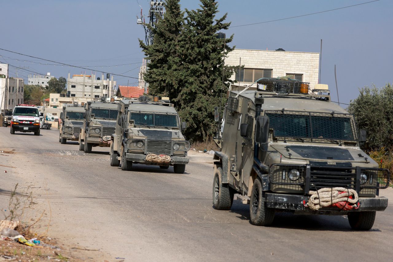 A convoy of Israeli security forces' vehicles drives through Aqaba village in the occupied West Bank during a raid on November 9, 2024.