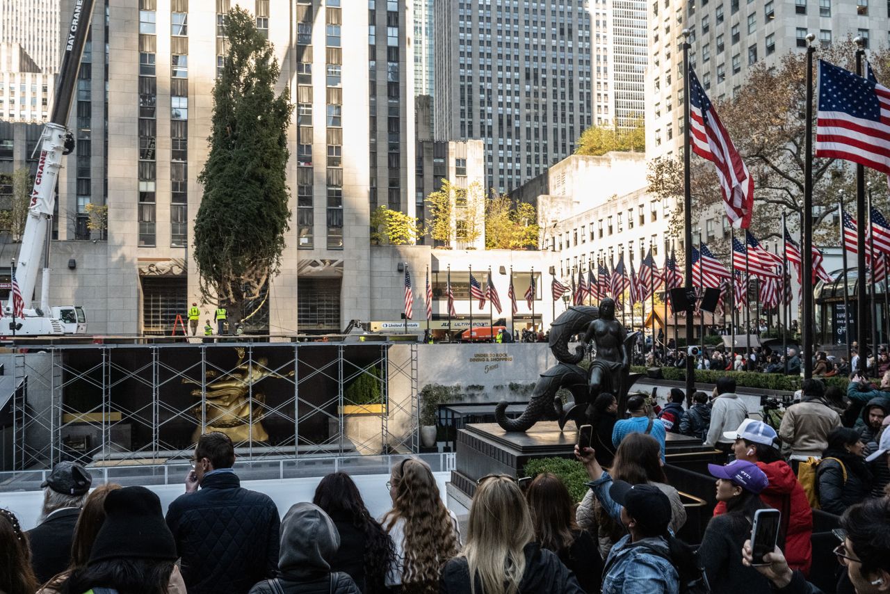 Spectators watch as the Rockefeller Christmas tree is installed on November 9 in New York.