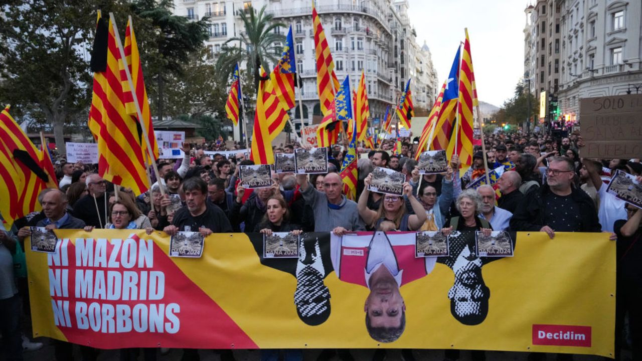 People carry a banner during a demonstration to demand the resignation of Valencia Regional President Carlos Mazon in Valencia on November 9, 2024. The European nation's worst floods in a generation have killed at least 220 people, left dozens missing and submerged entire towns in mud, particularly in the eastern Valencia region. (Photo by Cesar Manso / AFP) (Photo by CESAR MANSO/AFP via Getty Images)