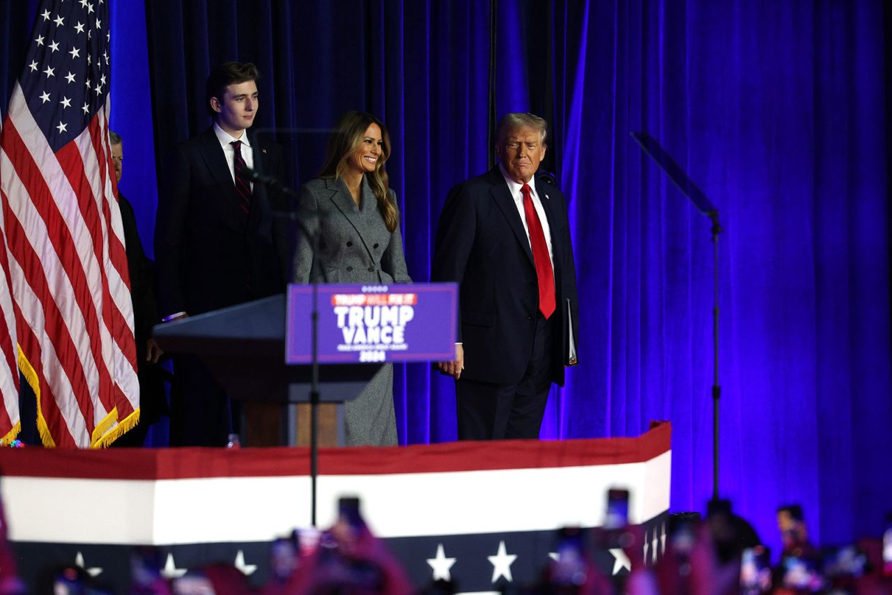 Former President Donald Trump arrives with former first lady Melania Trump and Barron Trump during an election night event at the Palm Beach Convention Center on November 6, in West Palm Beach, Florida.