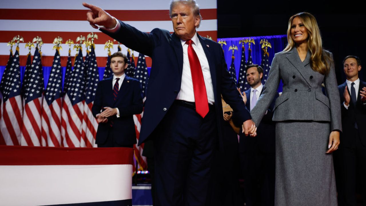 WEST PALM BEACH, FLORIDA - NOVEMBER 06:  Republican presidential nominee, former U.S. President Donald Trump points to supporters with former first lady Melania Trump during an election night event at the Palm Beach Convention Center on November 06, 2024 in West Palm Beach, Florida. Americans cast their ballots today in the presidential race between Republican nominee former President Donald Trump and Vice President Kamala Harris, as well as multiple state elections that will determine the balance of power in Congress.   (Photo by Chip Somodevilla/Getty Images)