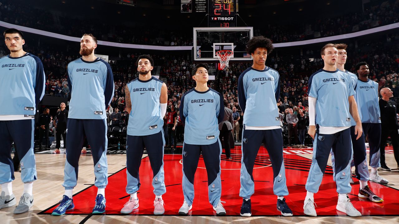 Yuki Kawamura, center, stands for the National Anthem alongside his Memphis Grizzlies teammates before a game against the Portland Trail Blazers at the Moda Center Arena in Portland, Oregon, on November 10, 2024.