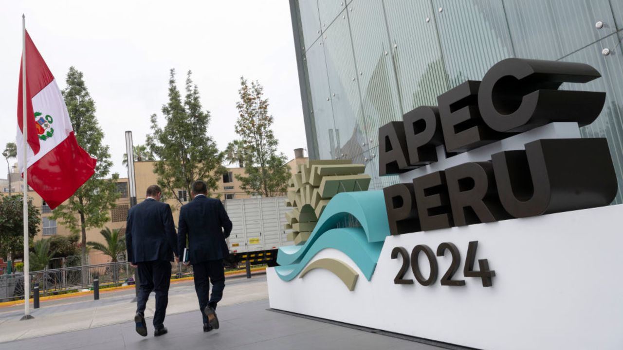 People walk by the entrance of the Lima Convention Center, part of the government complex where the Asia-Pacific Economic Cooperation (APEC) Summit will take place, in Lima on November 11, 2024. Leaders and representatives of the APEC 21 member economies and other commercial guests will meet in Lima from November 14 to 16. (Photo by Cris BOURONCLE / AFP) (Photo by CRIS BOURONCLE/AFP via Getty Images)