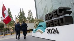 People walk by the entrance of the Lima Convention Center, part of the government complex where the Asia-Pacific Economic Cooperation (APEC) Summit will take place, in Lima on November 11, 2024. Leaders and representatives of the APEC 21 member economies and other commercial guests will meet in Lima from November 14 to 16. (Photo by Cris BOURONCLE / AFP) (Photo by CRIS BOURONCLE/AFP via Getty Images)