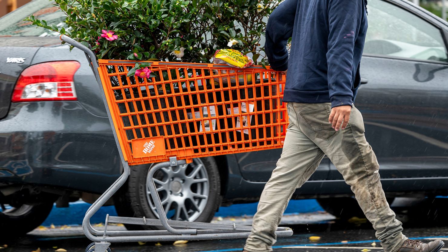 A customer pulls a shopping cart outside a Home Depot store in Palo Alto, California, US, on Monday, Nov. 11, 2024.