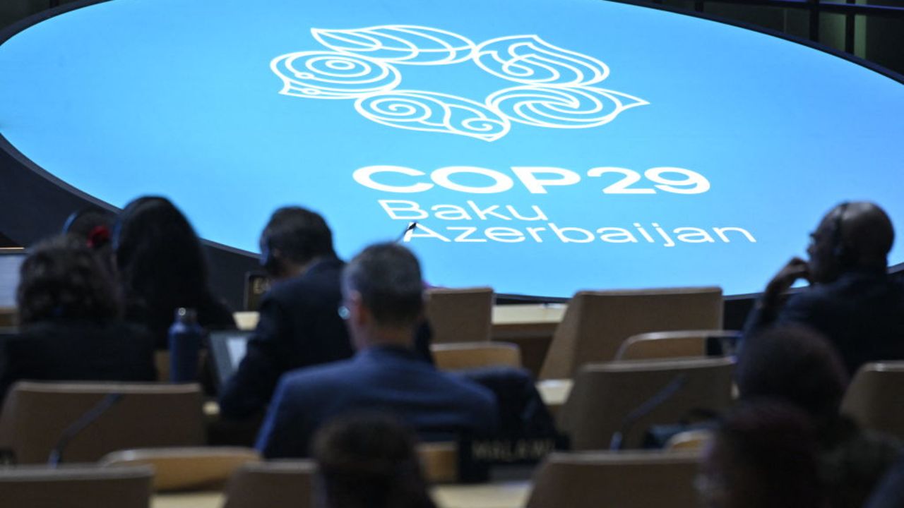 Participants listen to speeches during the United Nations Climate Change Conference (COP29) in Baku on November 13, 2024. (Photo by Alexander NEMENOV / AFP) (Photo by ALEXANDER NEMENOV/AFP via Getty Images)