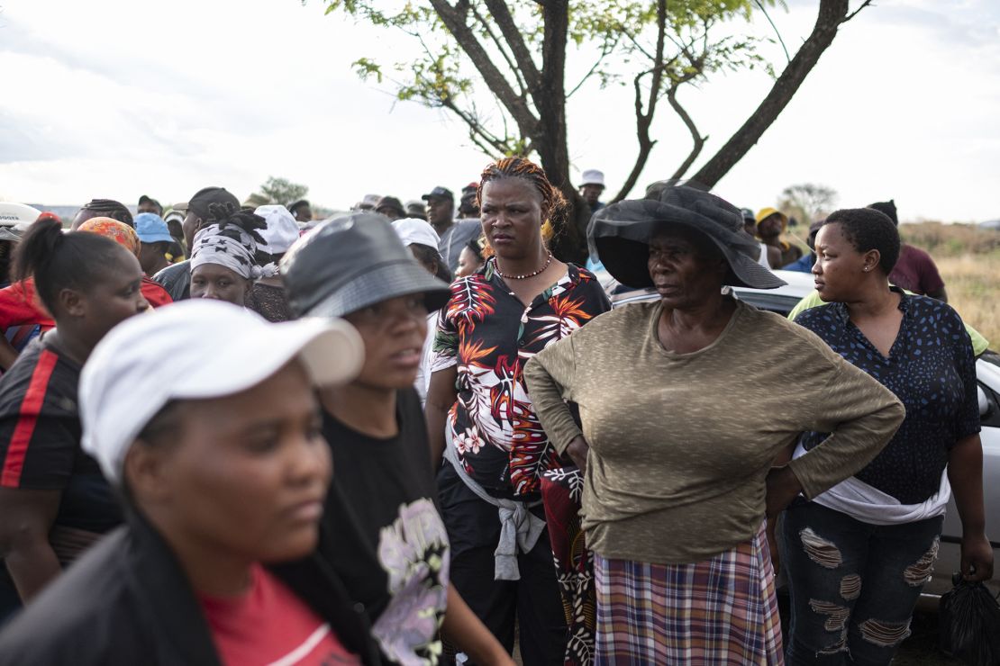 Relatives of miners and community members wait near an opening to the mine shaft for artisanal miners underground to resurface in Stilfontein on November 13, 2024.