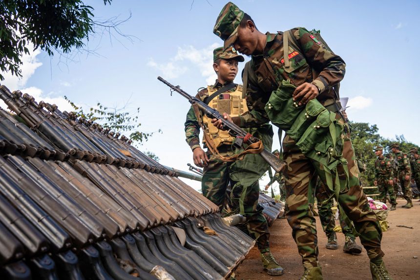 Members of Ta'ang National Liberation Army (TNLA) receive military equipment after getting special combat training in a secret jungle near Namhkam, Myanmar's northern Shan State on November 9, 2024.