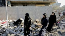 People walk through the rubble in Nuseirat refugee camp, central Gaza Strip, on November 12, 2024, following an Israeli strike. (Photo by Moiz Salhi / Middle East Images / Middle East Images via AFP) (Photo by MOIZ SALHI/Middle East Images/AFP via Getty Images)