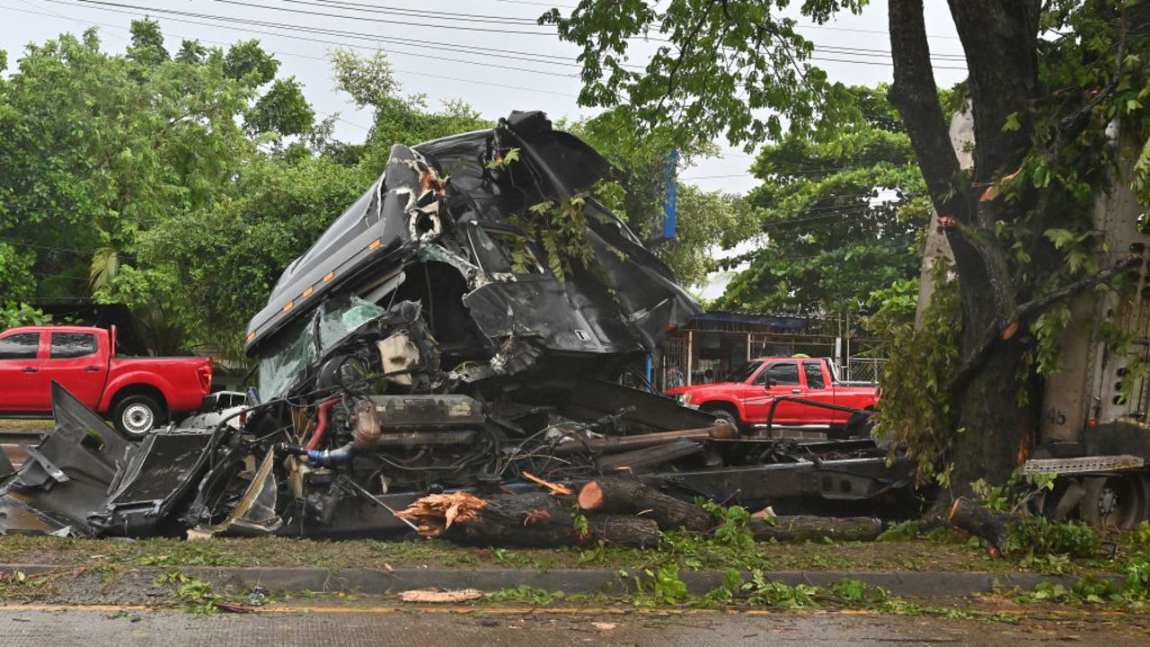 A truck that crashed into a tree due to heavy rains caused by tropical storm Sara is seen in Puerto Cortes, 240 km north of Tegucigalpa, on November 15, 2024. Honduras' President Xiomara Castro said emergency services had been activated to deal with "damage already caused by the rains," warning that Sara's impacts "could become a catastrophic event." (Photo by Orlando SIERRA / AFP) (Photo by ORLANDO SIERRA/AFP via Getty Images)